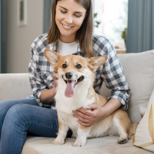 woman-holding-her-adorable-dog-couch